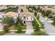 An aerial view of a charming neighborhood with well-maintained houses, green lawns, and mature trees at 1450 Rolling Fairway Dr, Davenport, FL 33896