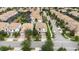 Wide aerial view of a residential area showcasing the harmonious layout of houses, greenery, and roads in a suburban setting at 1450 Rolling Fairway Dr, Davenport, FL 33896