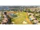 Expansive aerial view of the community showcasing the golf course, pond, and residential homes at 1450 Rolling Fairway Dr, Davenport, FL 33896