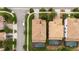 Overhead shot of homes with beautiful roofs, manicured lawns, and private screened-in pools in a quiet neighborhood at 1450 Rolling Fairway Dr, Davenport, FL 33896