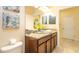 Bathroom with a granite vanity, framed mirrors, and contemporary fixtures at 1450 Rolling Fairway Dr, Davenport, FL 33896