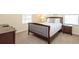Simple bedroom with a full bed, natural light, and functional furnishings, offering comfort and practicality at 1450 Rolling Fairway Dr, Davenport, FL 33896