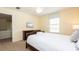 Bedroom featuring a queen bed, television, and natural light, providing a relaxing space at 1450 Rolling Fairway Dr, Davenport, FL 33896