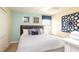 Bright bedroom featuring a cozy bed, modern decor, and a window for natural light at 1450 Rolling Fairway Dr, Davenport, FL 33896