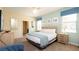 Bedroom with a view of the bathroom, a large bed, and soft lighting at 1450 Rolling Fairway Dr, Davenport, FL 33896