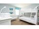 Bedroom with bunk beds, white furniture, and soft blue walls at 1450 Rolling Fairway Dr, Davenport, FL 33896