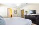 Bedroom featuring a queen bed, television, and an ensuite bathroom, providing comfort and convenience at 1450 Rolling Fairway Dr, Davenport, FL 33896