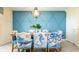 Stylish dining room with nautical-themed decor and seating for eight at 1450 Rolling Fairway Dr, Davenport, FL 33896