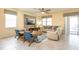 Comfortable living room features tile floors, neutral paint, ceiling fan, and cozy seating at 1450 Rolling Fairway Dr, Davenport, FL 33896