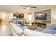Open-concept living area with kitchen view, modern decor, and comfortable seating arrangement at 1450 Rolling Fairway Dr, Davenport, FL 33896