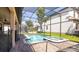 Sparkling pool and spa with screened enclosure and brick paver deck, perfect for outdoor relaxation and entertaining at 1450 Rolling Fairway Dr, Davenport, FL 33896