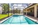 Sparkling pool and spa area with screened enclosure and outdoor seating at 1450 Rolling Fairway Dr, Davenport, FL 33896