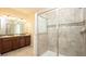 Bathroom with tiled walk-in shower featuring glass doors and decorative tile accent at 1450 Rolling Fairway Dr, Davenport, FL 33896