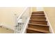 Staircase with wood stairs and white railings at 1450 Rolling Fairway Dr, Davenport, FL 33896