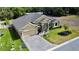 Aerial view of the home, featuring the manicured lawn, the driveway, and the lovely landscaping at 1568 Cordgrass Way, Lakeland, FL 33813