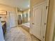 Bright bathroom featuring a glass enclosed shower, soaking tub, and tile flooring at 1568 Cordgrass Way, Lakeland, FL 33813