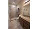 Bright bathroom features a granite-topped vanity and tiled stand-up shower at 1568 Cordgrass Way, Lakeland, FL 33813