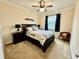 Comfortable bedroom with a ceiling fan, side tables, and natural light at 1568 Cordgrass Way, Lakeland, FL 33813