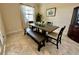 Bright dining room featuring a wooden table, bench seating, and neutral decor for a warm and inviting atmosphere at 1568 Cordgrass Way, Lakeland, FL 33813