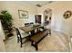 Dining room featuring a wooden table, bench seating, and stylish decor adjacent to the kitchen area at 1568 Cordgrass Way, Lakeland, FL 33813