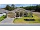 Beautiful single-story home with manicured lawn, stone accents, and a brick driveway at 1568 Cordgrass Way, Lakeland, FL 33813