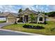 Beautiful home showcasing a well-manicured front yard and stone accents at 1568 Cordgrass Way, Lakeland, FL 33813