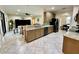 Kitchen with granite counters and stainless appliances open to dining and living rooms at 1568 Cordgrass Way, Lakeland, FL 33813