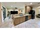 Kitchen featuring a breakfast bar with granite counters and sleek appliances open to living room at 1568 Cordgrass Way, Lakeland, FL 33813