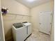 Neat laundry room with a washing machine, dryer, and shelving at 1568 Cordgrass Way, Lakeland, FL 33813