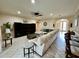 Spacious living room with tile floors, a ceiling fan, and comfortable sectional seating at 1568 Cordgrass Way, Lakeland, FL 33813