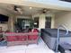 Outdoor patio featuring ceiling fans, comfortable seating, and a hot tub for year-round enjoyment at 1568 Cordgrass Way, Lakeland, FL 33813