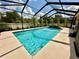 Private in-ground screened-in pool offers an oasis for relaxation at 1568 Cordgrass Way, Lakeland, FL 33813