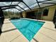Relaxing screened-in pool with clear blue water and a built-in waterfall feature perfect for outdoor enjoyment at 1568 Cordgrass Way, Lakeland, FL 33813