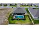 An aerial shot highlights a screened in pool, manicured lawn, and a fenced in backyard at 1568 Cordgrass Way, Lakeland, FL 33813