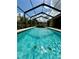 Inviting screened-in pool with shimmering water, perfect for a refreshing swim on a sunny day at 1568 Cordgrass Way, Lakeland, FL 33813