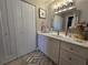 Bathroom featuring a spacious vanity with a large mirror and ample storage at 200 Maitland Ave # 114, Altamonte Springs, FL 32701