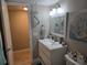 Clean bathroom with a modern vanity, decorative mirror, and tiled floors at 200 Maitland Ave # 114, Altamonte Springs, FL 32701