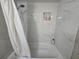 Bright and modern bathroom featuring a tiled shower with built-in shelving at 200 Maitland Ave # 114, Altamonte Springs, FL 32701
