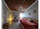 Charming bedroom featuring a wood plank ceiling and plush decor at 200 Maitland Ave # 114, Altamonte Springs, FL 32701