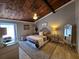 Cozy bedroom with wood-paneled vaulted ceiling, ceiling fan, and a plush patterned rug at 200 Maitland Ave # 114, Altamonte Springs, FL 32701