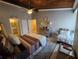 Bedroom with wood paneled ceiling, ceiling fan, and bathroom access at 200 Maitland Ave # 114, Altamonte Springs, FL 32701