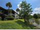 Scenic exterior view of lakeside home with lush landscaping and mature palm trees at 200 Maitland Ave # 114, Altamonte Springs, FL 32701