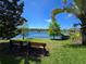 Picturesque lake view with benches, canoes, lush landscaping, and mature trees at 200 Maitland Ave # 114, Altamonte Springs, FL 32701