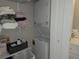 Convenient laundry area with stacked washer and dryer, and shelving for storage at 200 Maitland Ave # 114, Altamonte Springs, FL 32701