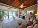 Inviting living room featuring a cozy brown sofa and large windows with scenic waterfront views at 200 Maitland Ave # 114, Altamonte Springs, FL 32701