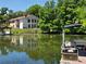 Waterfront view of home with a dock, surrounded by lush greenery and clear water at 200 Maitland Ave # 114, Altamonte Springs, FL 32701