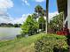 Beautiful waterfront view with lush landscaping, including palm trees, and stunning water views at 200 Maitland Ave # 114, Altamonte Springs, FL 32701