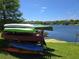 View of the lake featuring several canoes stacked on a rack and clear blue sky at 200 Maitland Ave # 114, Altamonte Springs, FL 32701