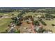 Aerial view of a property surrounded by lush greenery, open fields, and a defined boundary at 2899 Sw 66 St, Ocala, FL 34476