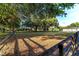 Expansive backyard featuring mature trees and a wooden fence, creating a serene outdoor environment at 2899 Sw 66 St, Ocala, FL 34476